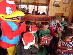 Red Robin Mascot Red with Children at Shop With Cops Event, Exchanging Gifts